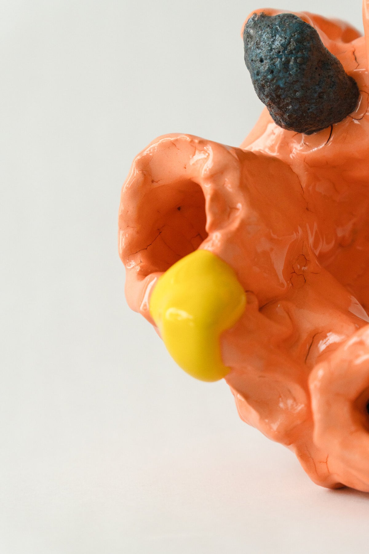 Foam #1 by Onree: Orange looping ceramic form with several openings, bright glazed accents and dark textured projections — additional view 1