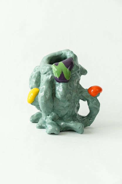 Foam #2 by Onree: Pale green ceramic vessel with an irregular body, orange and yellow accents, and a green-and-purple detail — full view