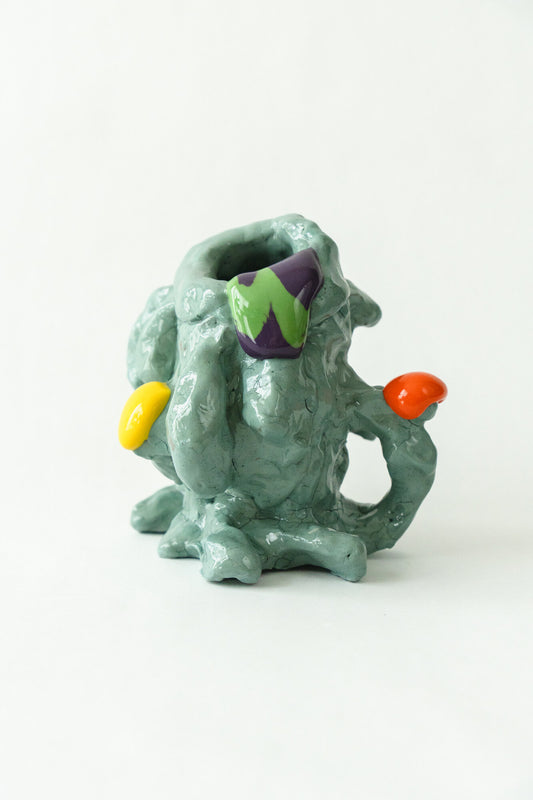 Foam #2 by Onree: Pale green ceramic vessel with an irregular body, orange and yellow accents, and a green-and-purple detail — full view