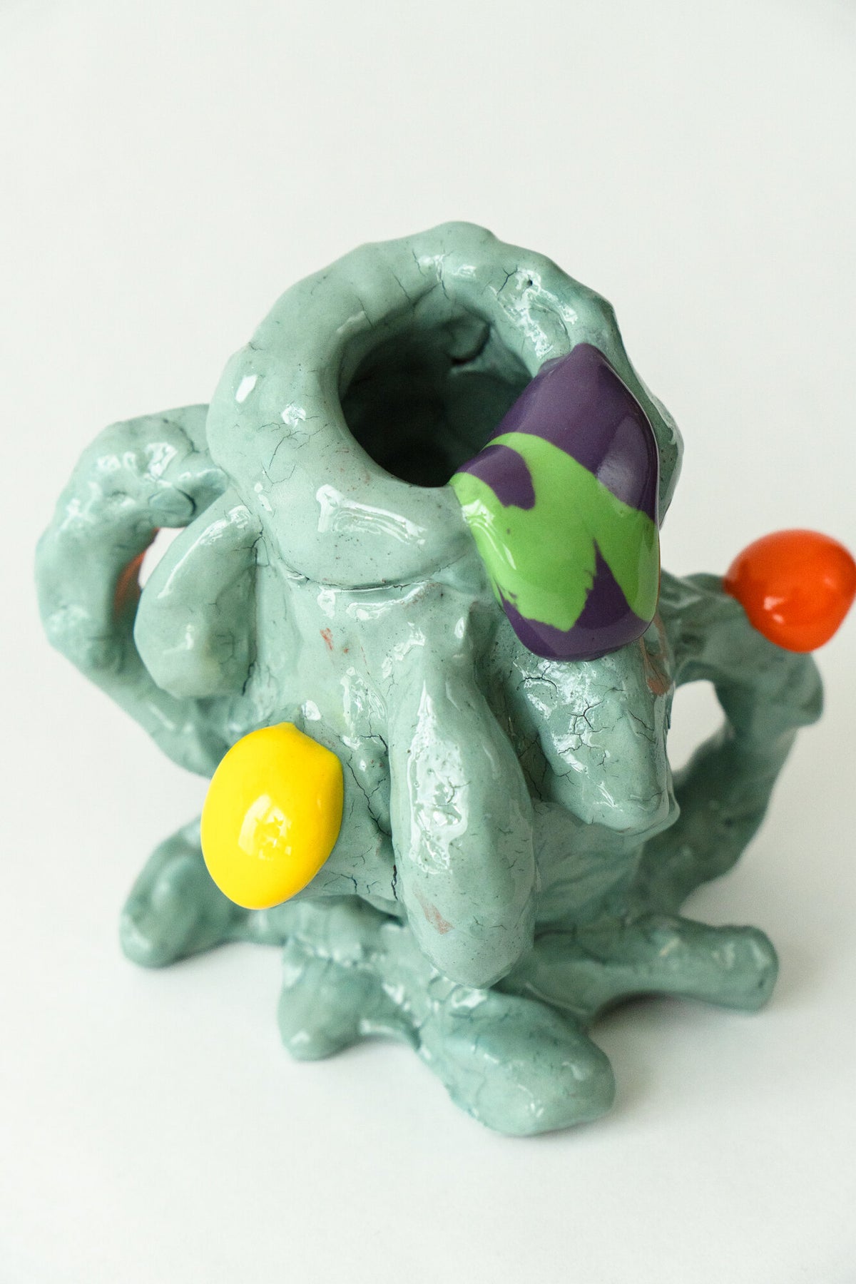 Foam #2 by Onree: Pale green ceramic vessel with an irregular body, orange and yellow accents, and a green-and-purple detail — additional view 2