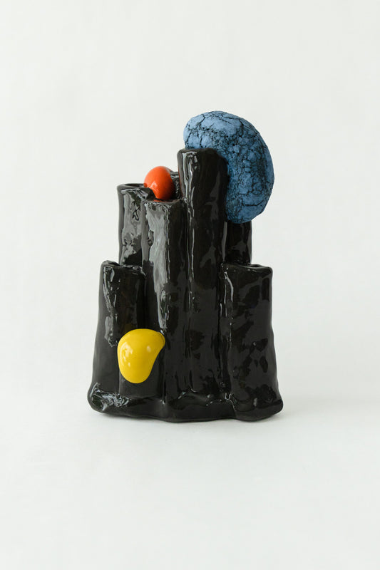 Foam #5 by Onree: Glossy black ceramic tubes with orange and yellow details and a textured blue disc — full view