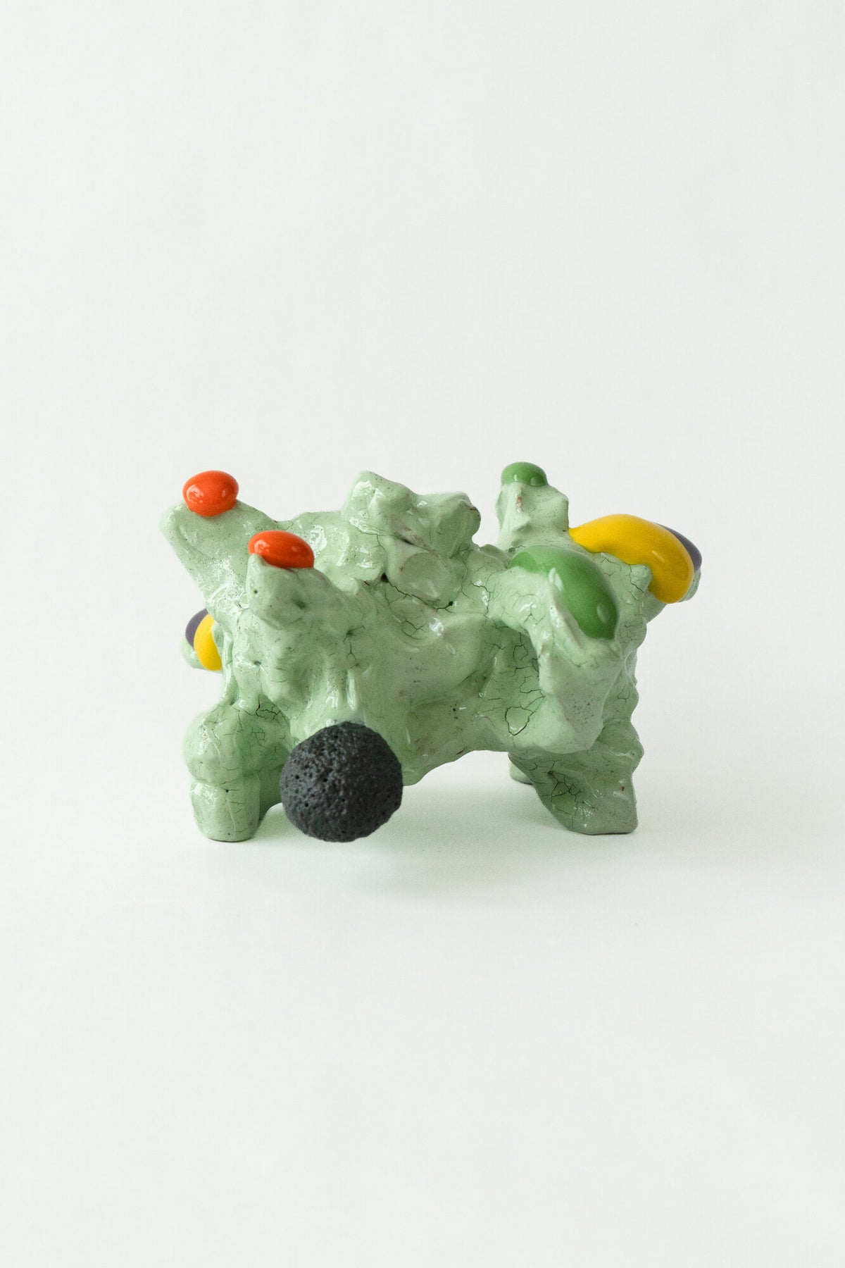 Foam #8 by Onree: Low pale green ceramic form with orange, yellow and dark accents — full view