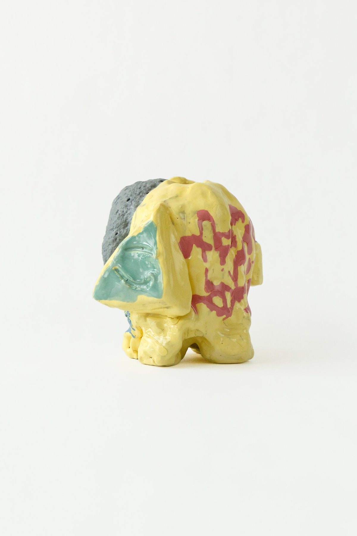Foam #13 by Onree: Yellow ceramic vessel with red markings, a pale green detail and a dark textured section — full view