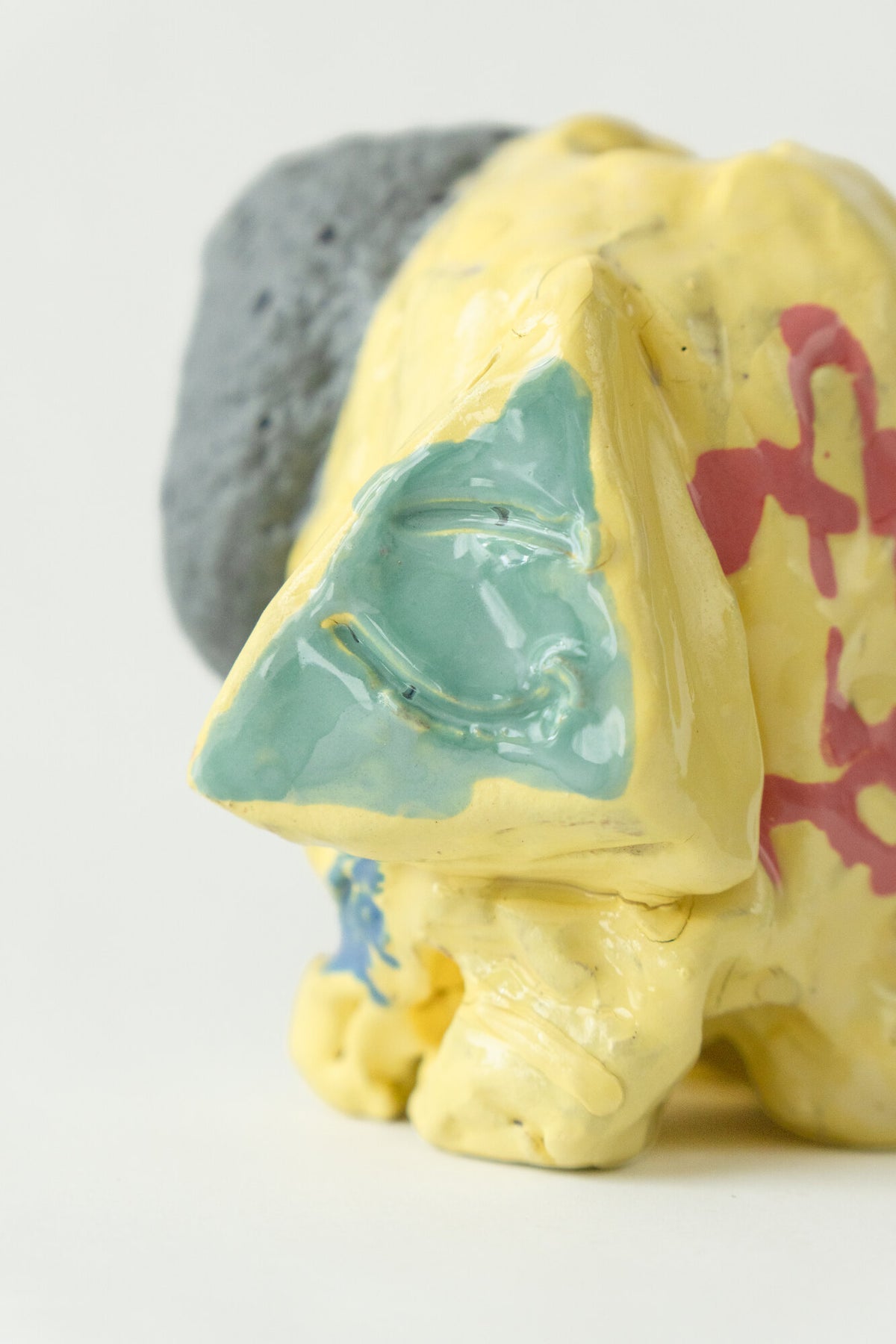 Foam #13 by Onree: Yellow ceramic vessel with red markings, a pale green detail and a dark textured section — additional view 2