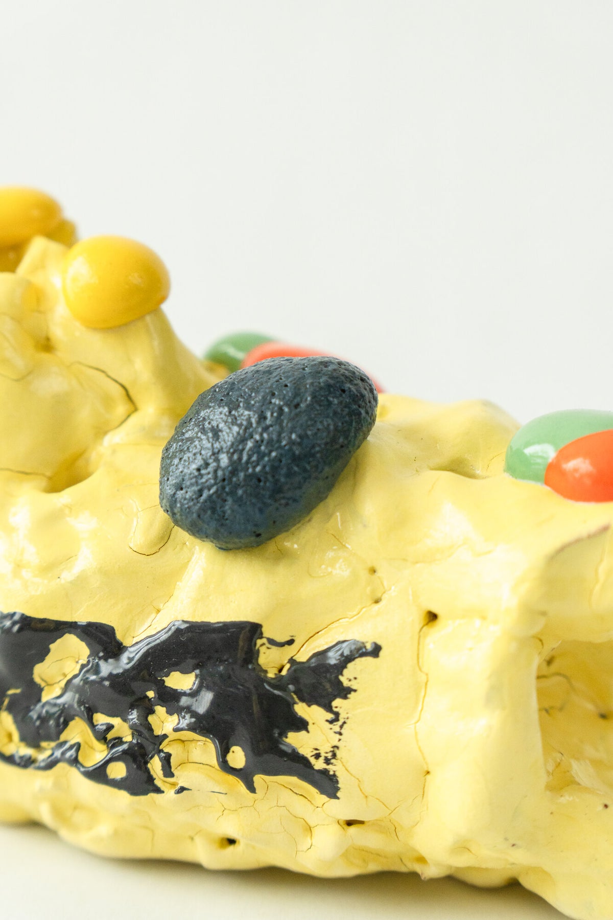 Foam #15 by Onree: Low yellow ceramic form with a black band and dark textured accents — additional view 1