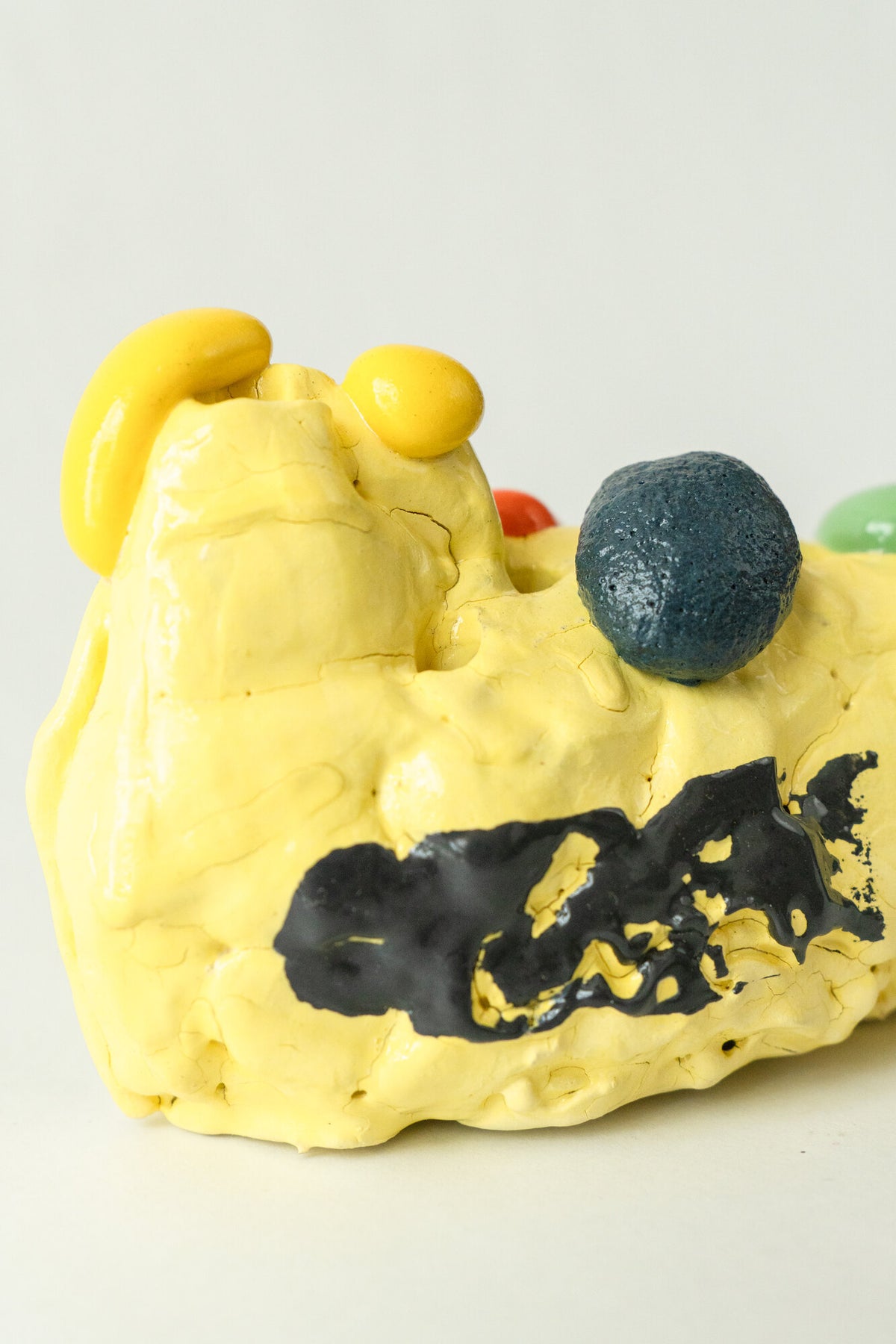 Foam #15 by Onree: Low yellow ceramic form with a black band and dark textured accents — additional view 2