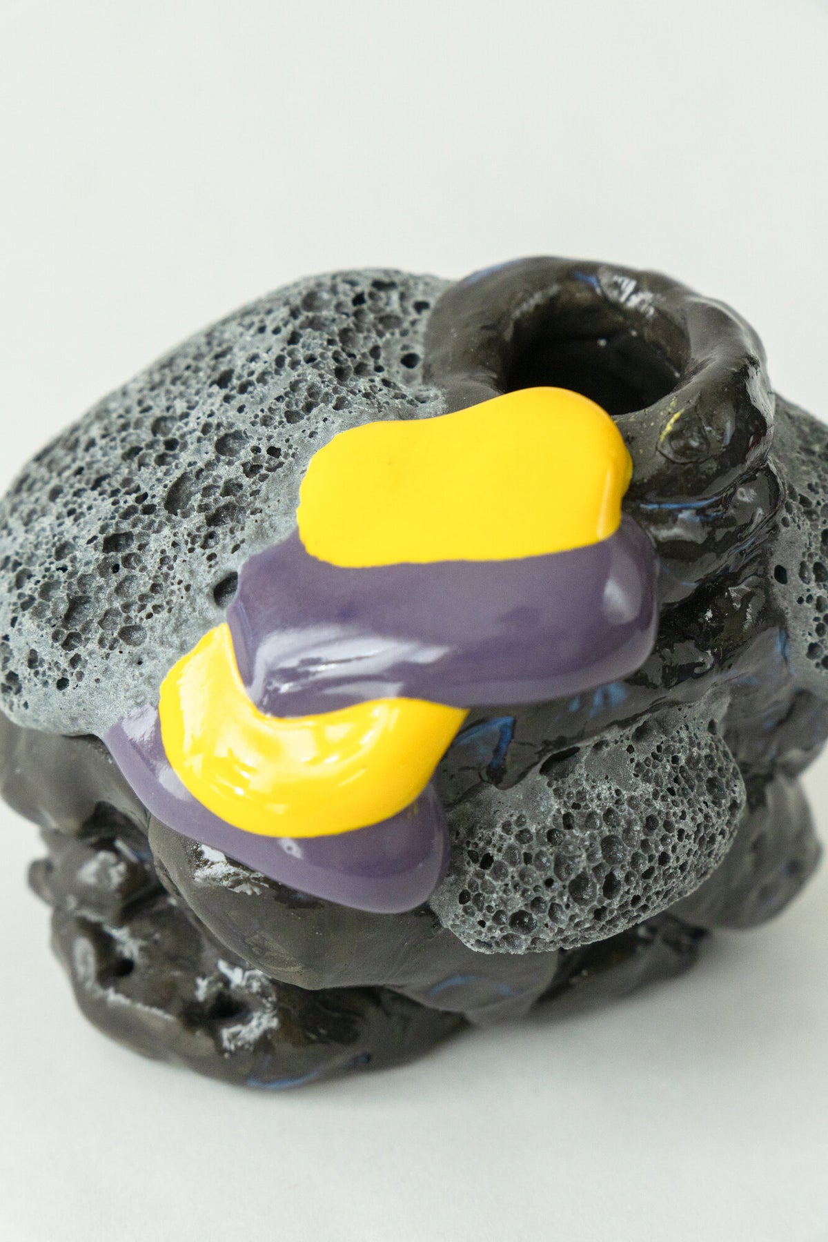 Foam #16 by Onree: Compact black ceramic form with textured grey details and yellow and purple glaze — additional view 1