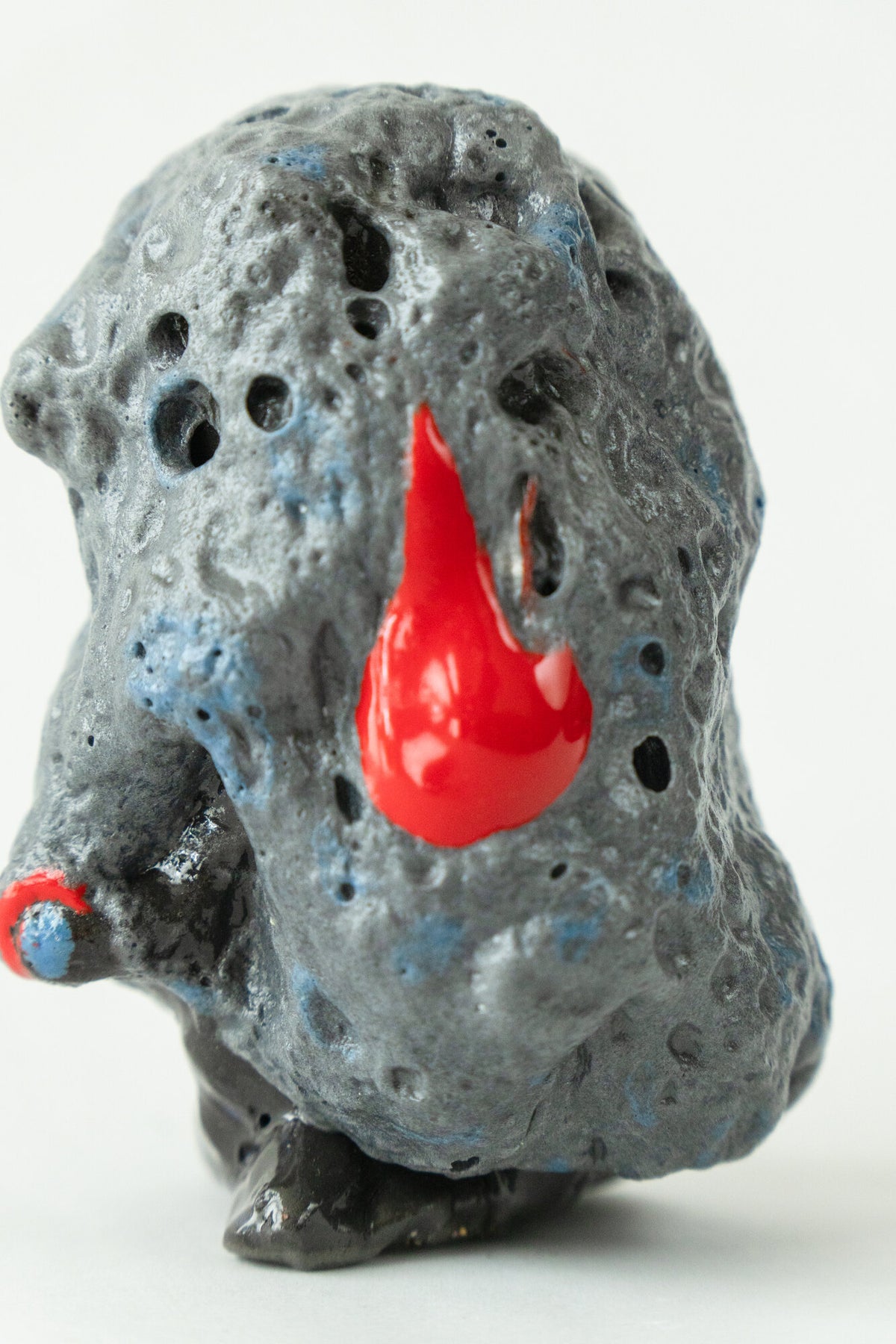 Foam #17 by Onree: Dark grey upright ceramic form with a pitted surface and red glazed accents — additional view 1