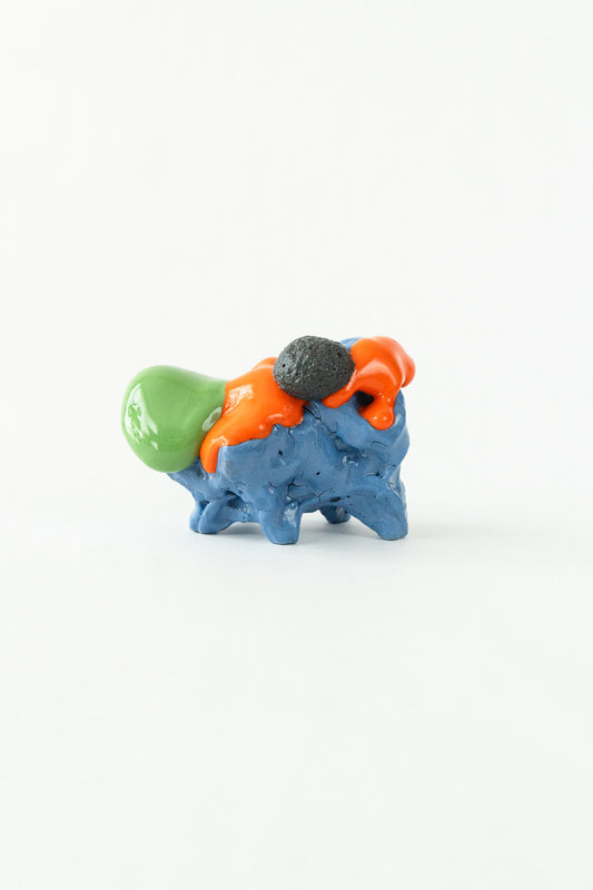 Foam #19 by Onree: Low blue ceramic form with orange glaze, a green projection and a dark textured disc — full view