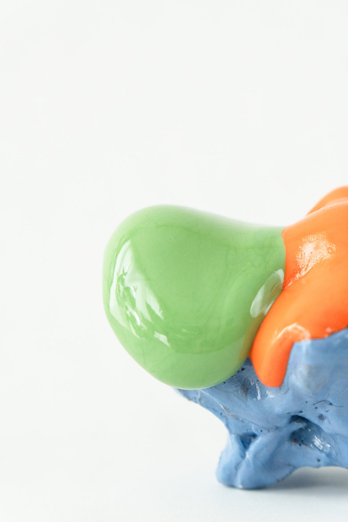 Foam #19 by Onree: Low blue ceramic form with orange glaze, a green projection and a dark textured disc — additional view 1