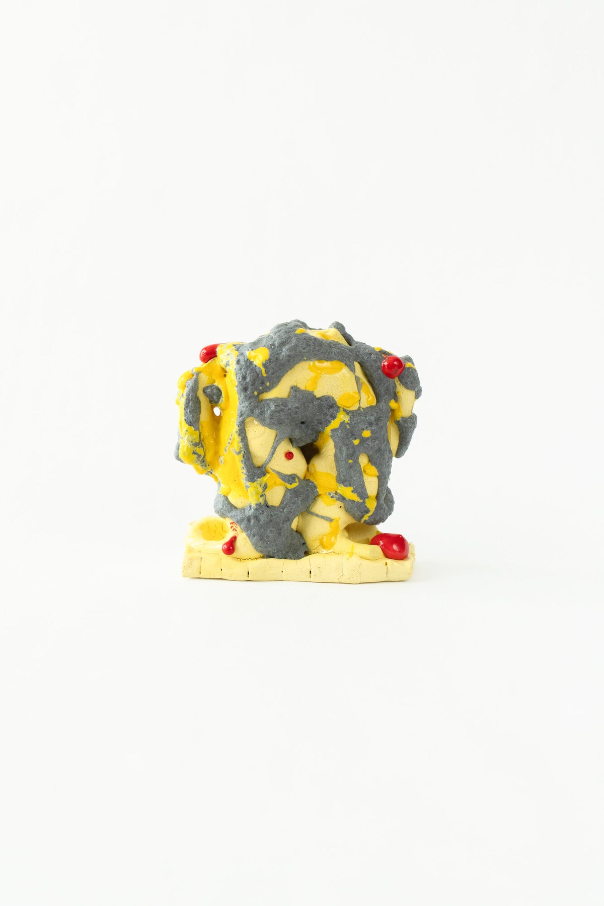 Foam #20 by Onree: Yellow ceramic vessel with coarse charcoal surfaces and small red glazed details — full view