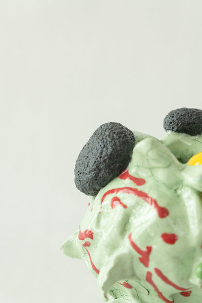 Foam #23 by Onree: Pale green ceramic vessel with red marks, dark textured circles and a yellow glazed detail — additional view 1