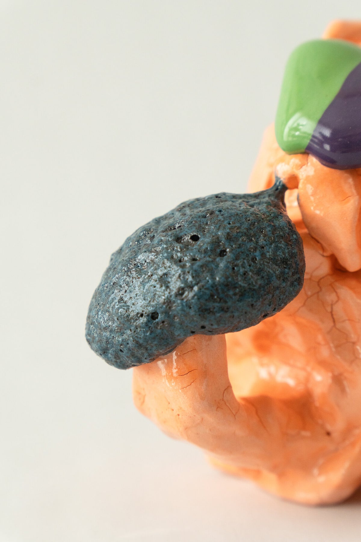 Foam #24 by Onree: Orange folded ceramic vessel with green and purple glaze and a dark side projection — additional view 2