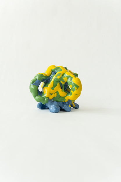 Foam #25 by Onree: Compact blue ceramic form covered in green and yellow glaze — full view