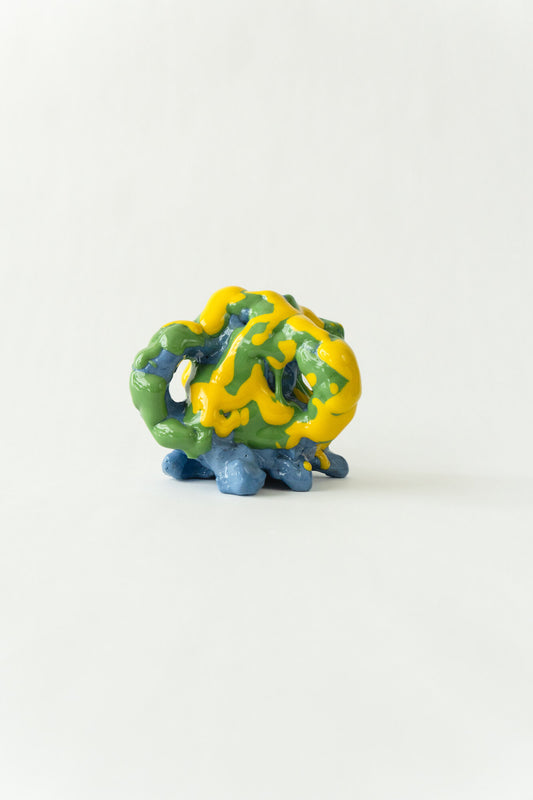 Foam #25 by Onree: Compact blue ceramic form covered in green and yellow glaze — full view