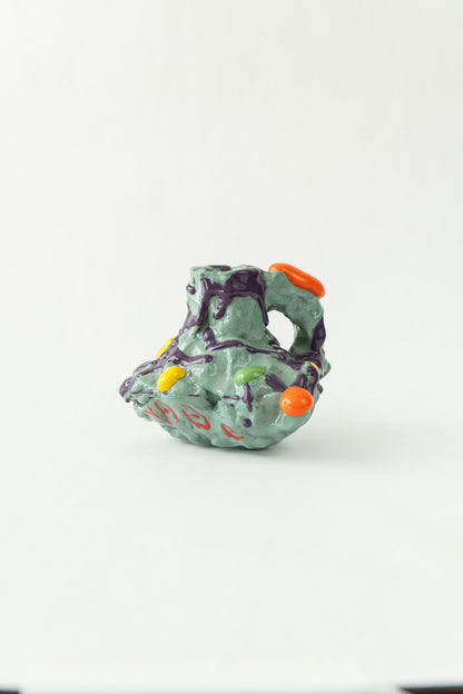 Foam #27 by Onree: Pale green ceramic vessel with deep openings, purple glaze and red marks — full view