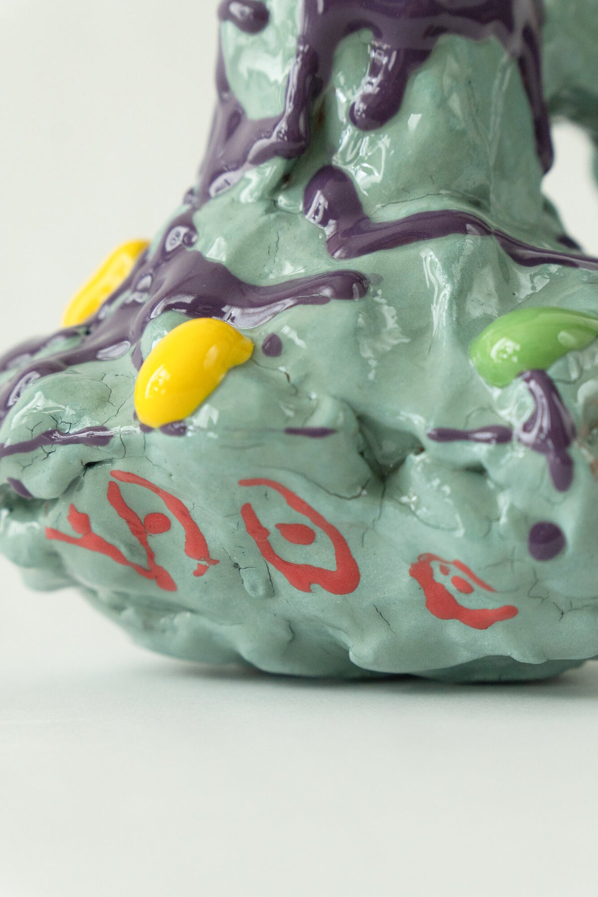 Foam #27 by Onree: Pale green ceramic vessel with deep openings, purple glaze and red marks — additional view 1