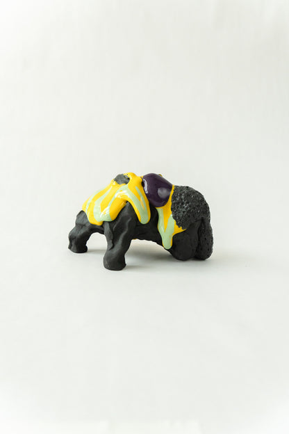 Foam #31 by Onree: Low black ceramic form with yellow, pale green and purple glaze — full view