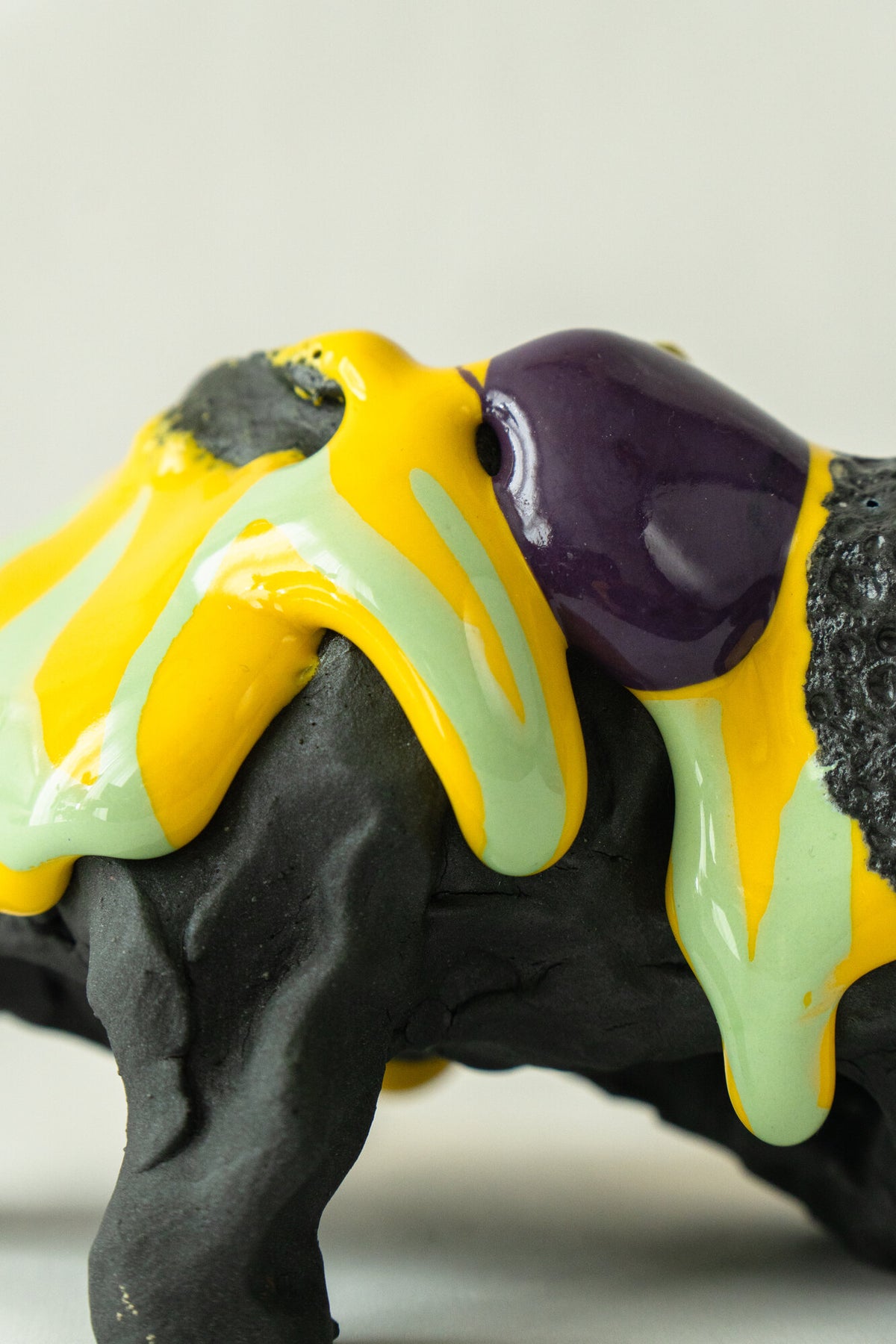 Foam #31 by Onree: Low black ceramic form with yellow, pale green and purple glaze — additional view 2