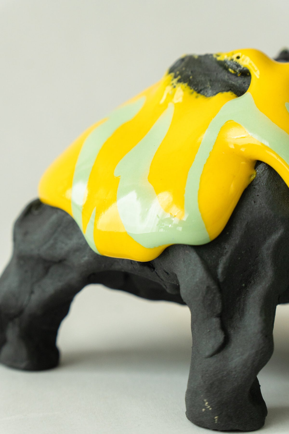 Foam #31 by Onree: Low black ceramic form with yellow, pale green and purple glaze — additional view 3