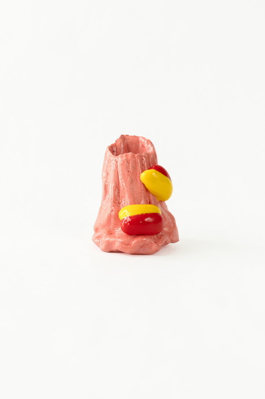 Foam #32 by Onree: Tapered pink ceramic vessel with vertical ridges and red and yellow glazed additions — full view