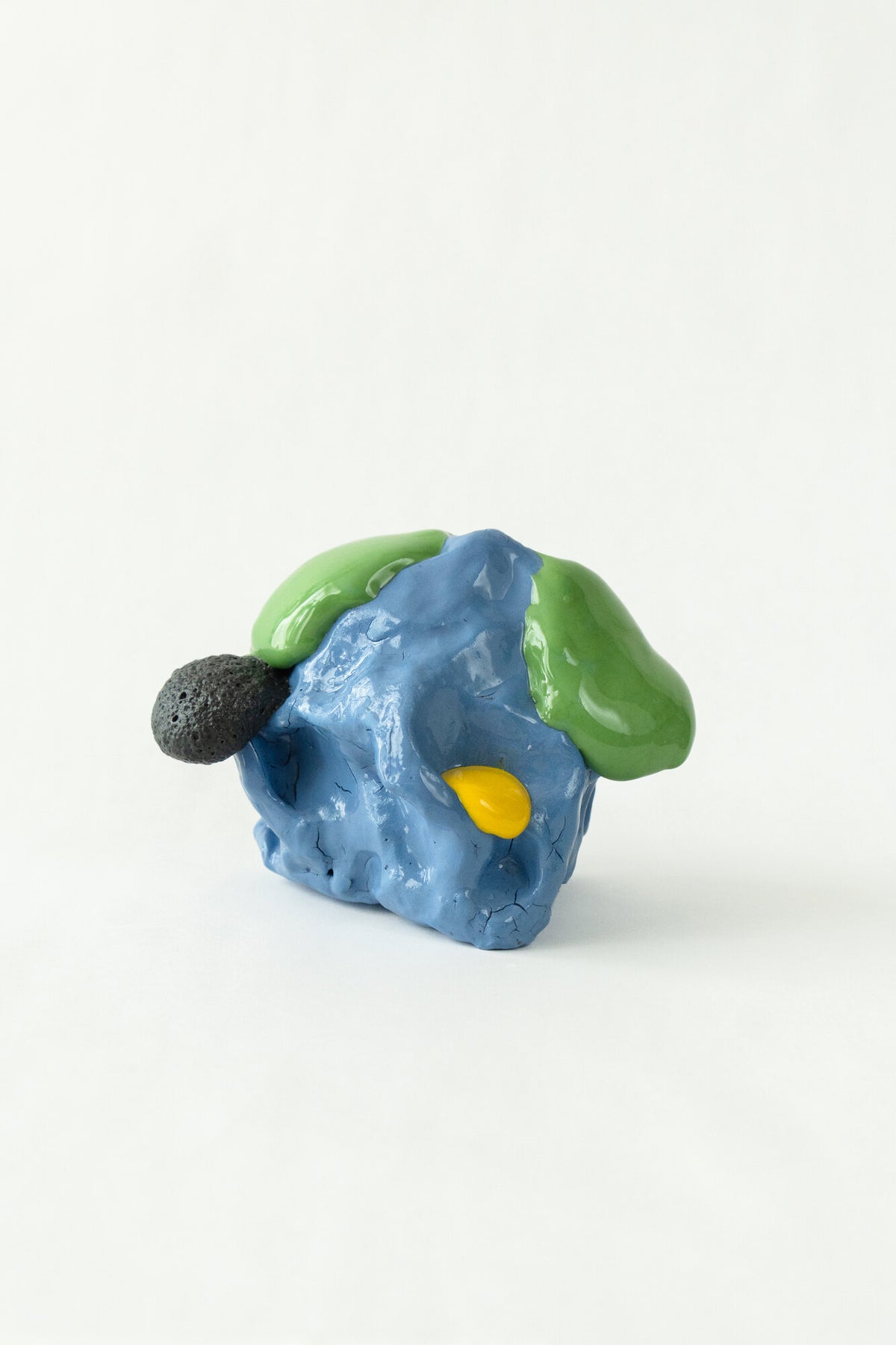 Foam #33 by Onree: Compact blue ceramic form with green glaze, a yellow accent and a dark textured projection — additional view 1