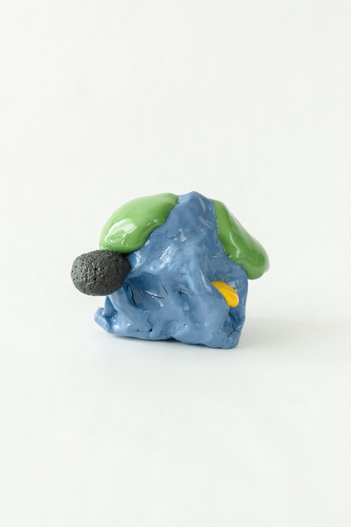 Foam #33 by Onree: Compact blue ceramic form with green glaze, a yellow accent and a dark textured projection — additional view 2
