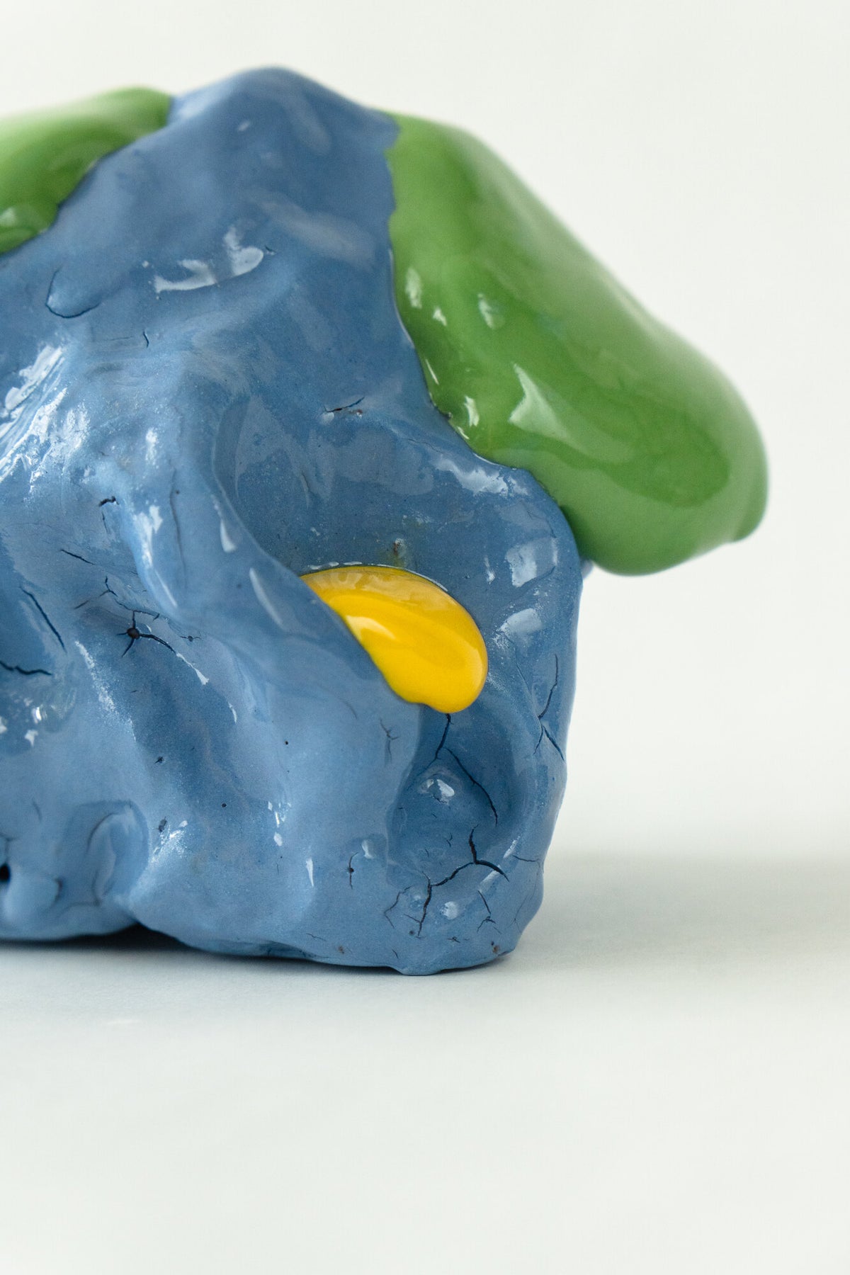 Foam #33 by Onree: Compact blue ceramic form with green glaze, a yellow accent and a dark textured projection — additional view 3