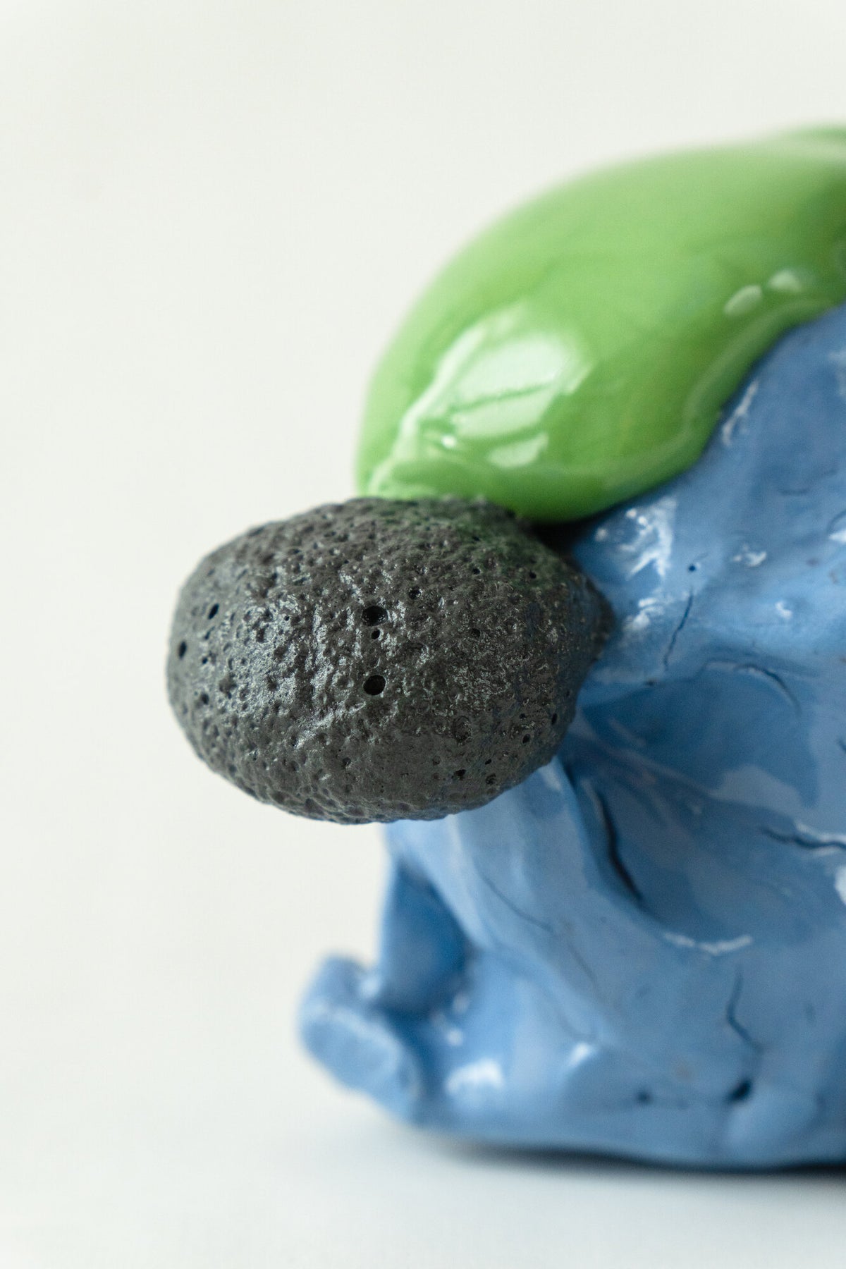 Foam #33 by Onree: Compact blue ceramic form with green glaze, a yellow accent and a dark textured projection — additional view 4