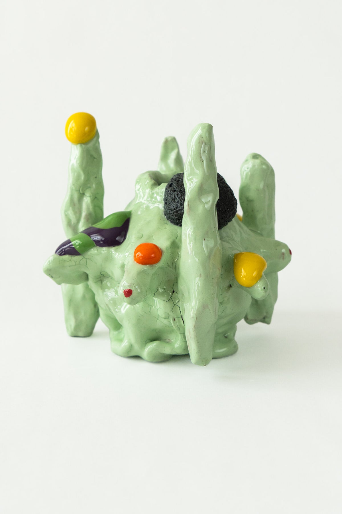 Foam #34 by Onree: Pale green ceramic form with slender upright towers and colourful raised details — full view