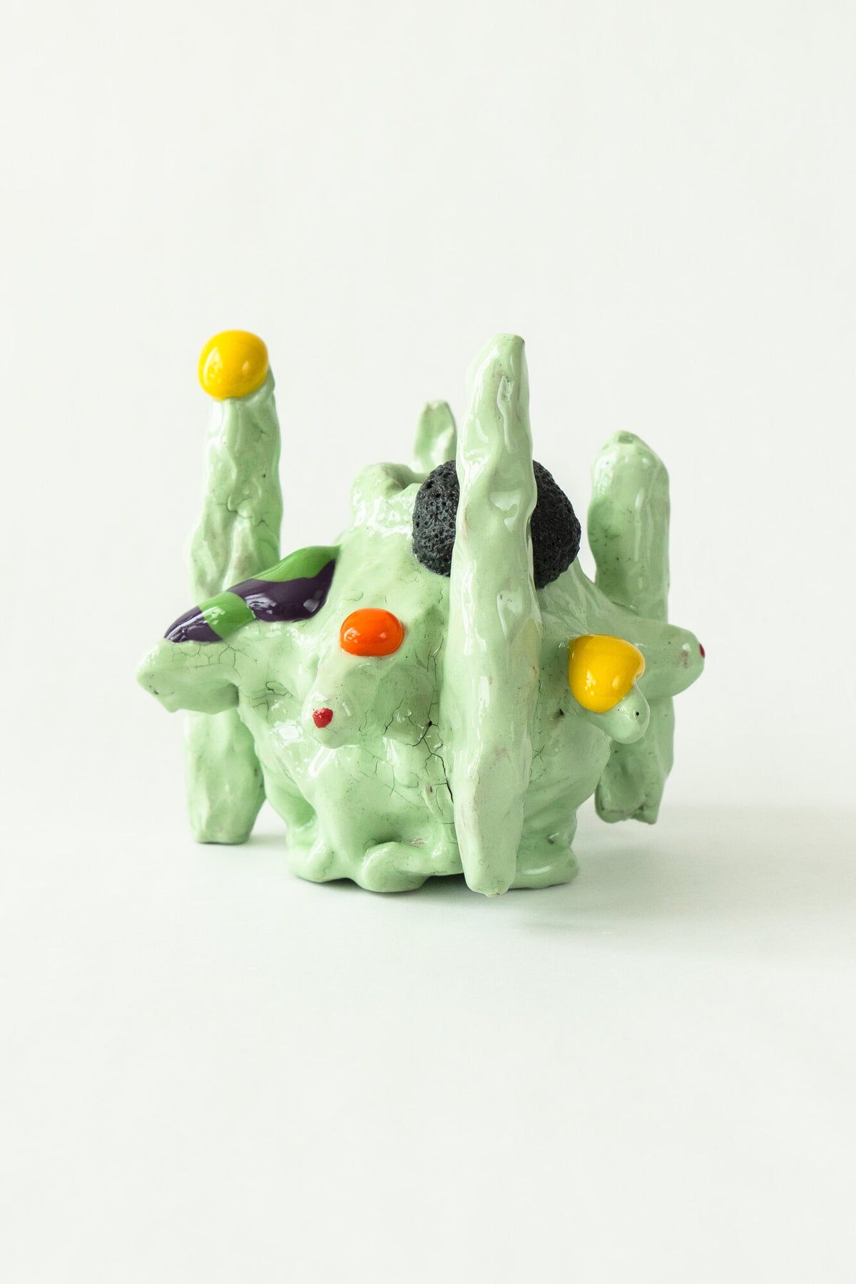 Foam #34 by Onree: Pale green ceramic form with slender upright towers and colourful raised details — additional view 1